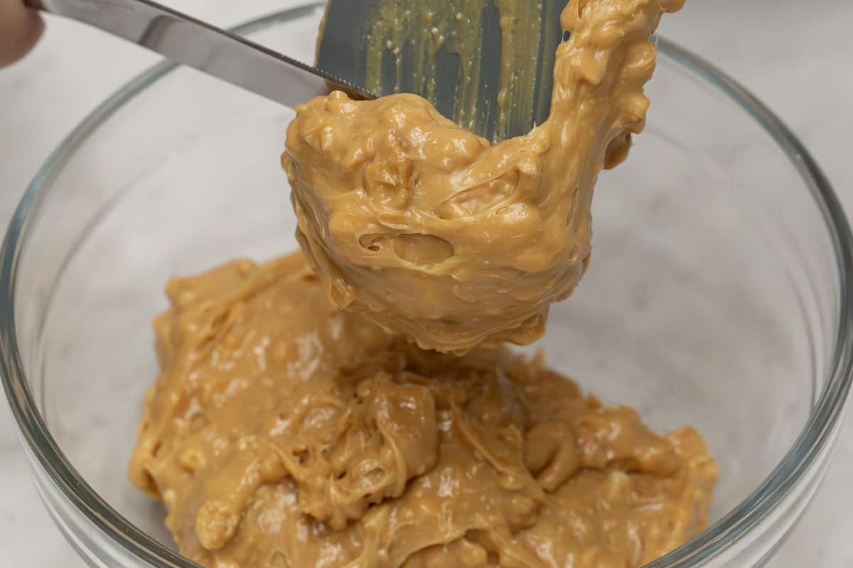 Scraping the yema off of the spatula using a bread knife.