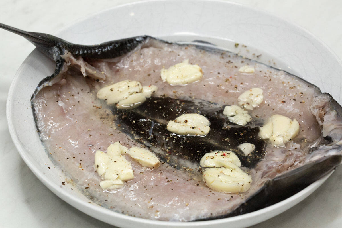 Milkfish marinating in vinegar and garlic.