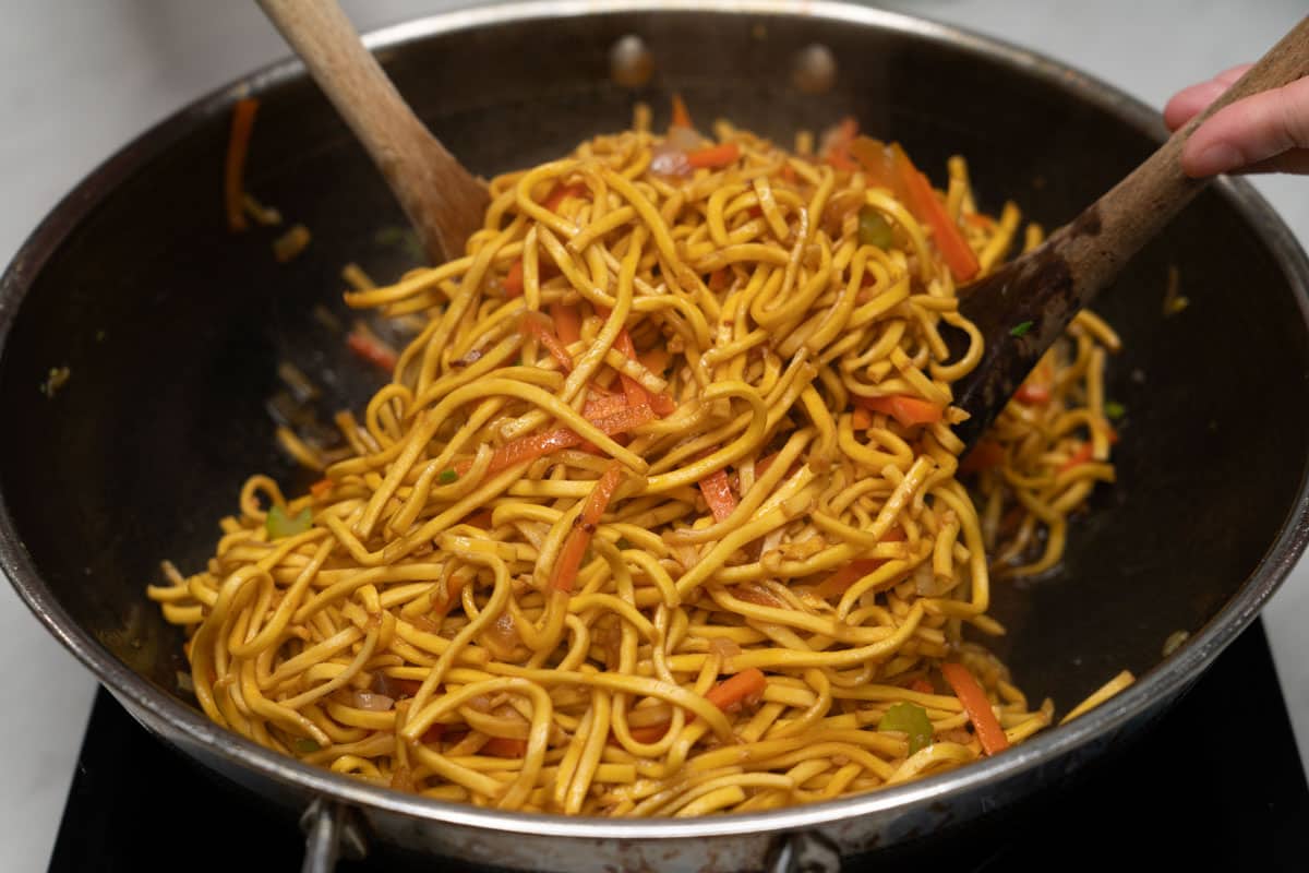 Tossing pancit canton noodles in a wok.