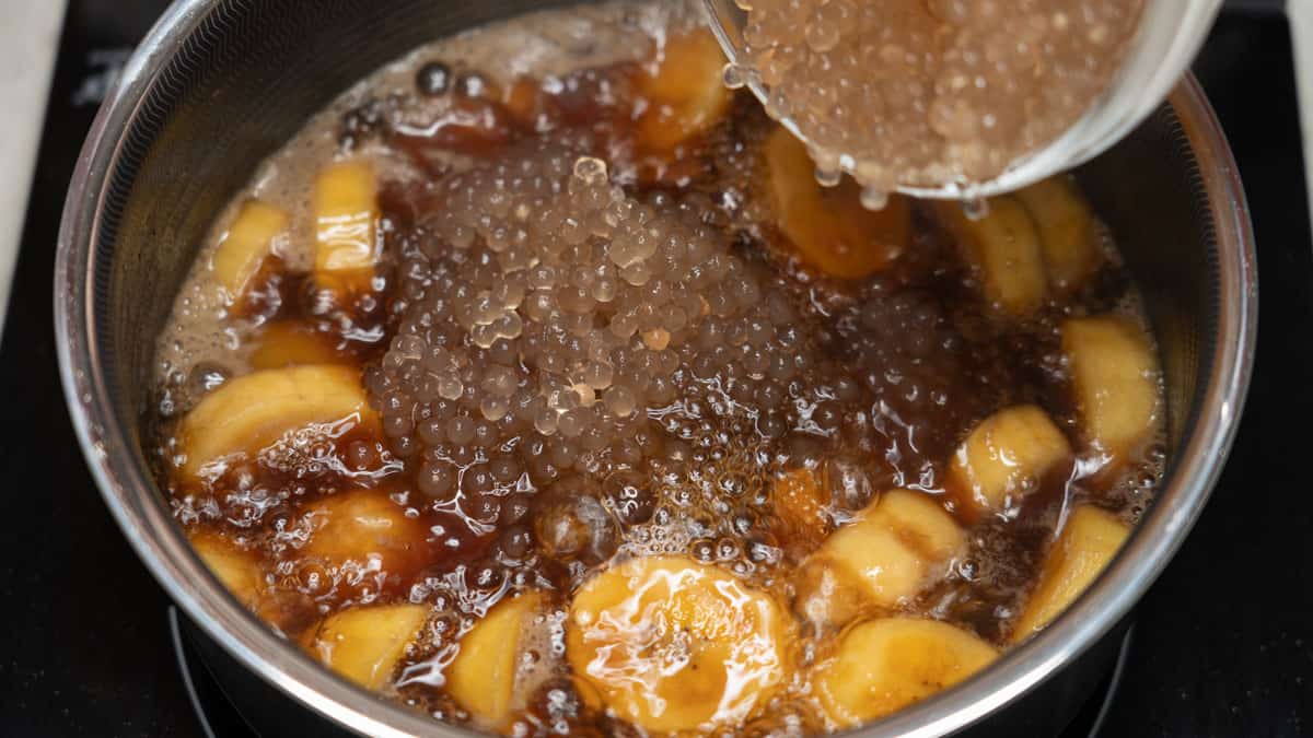 Minatamis na Saging (Sweetened Saba Bananas) with sago in a saucepan.