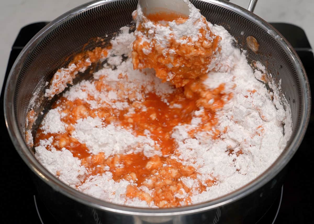 Rice flour mixed with water and achuete in a pot.
