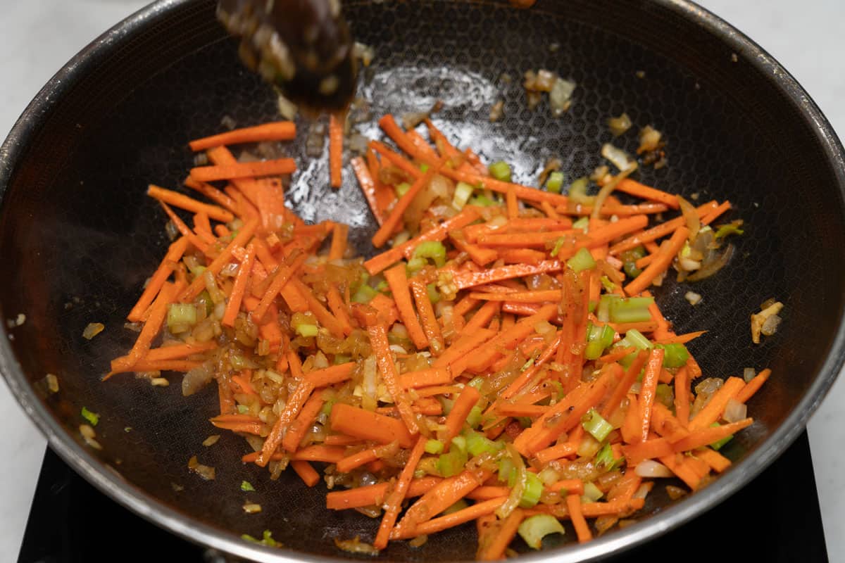 Sauteing carrots and celery in a wok.