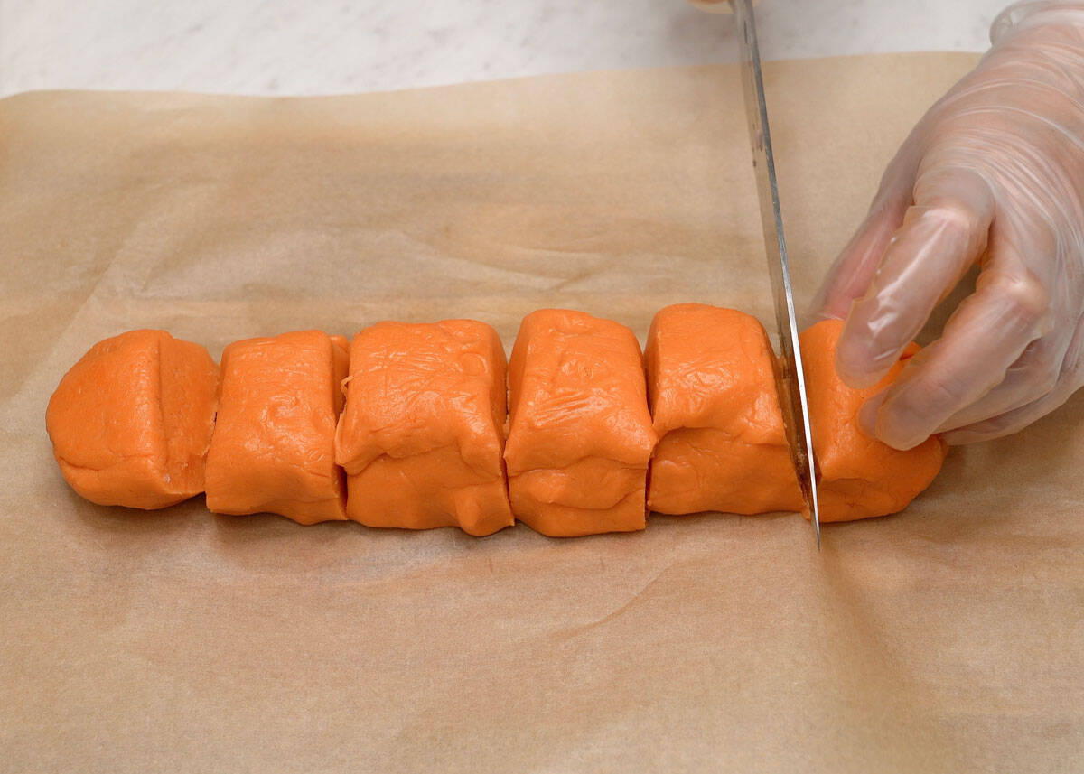 Cutting empanada dough in equal portions.