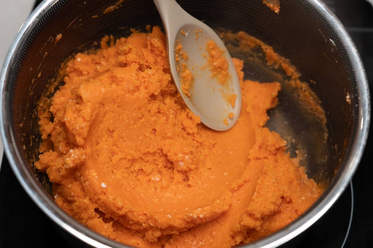 Mixing Ilocos empanada dough in a pot.