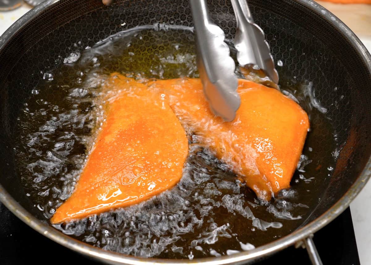 Frying Vigan empanada in a wok.