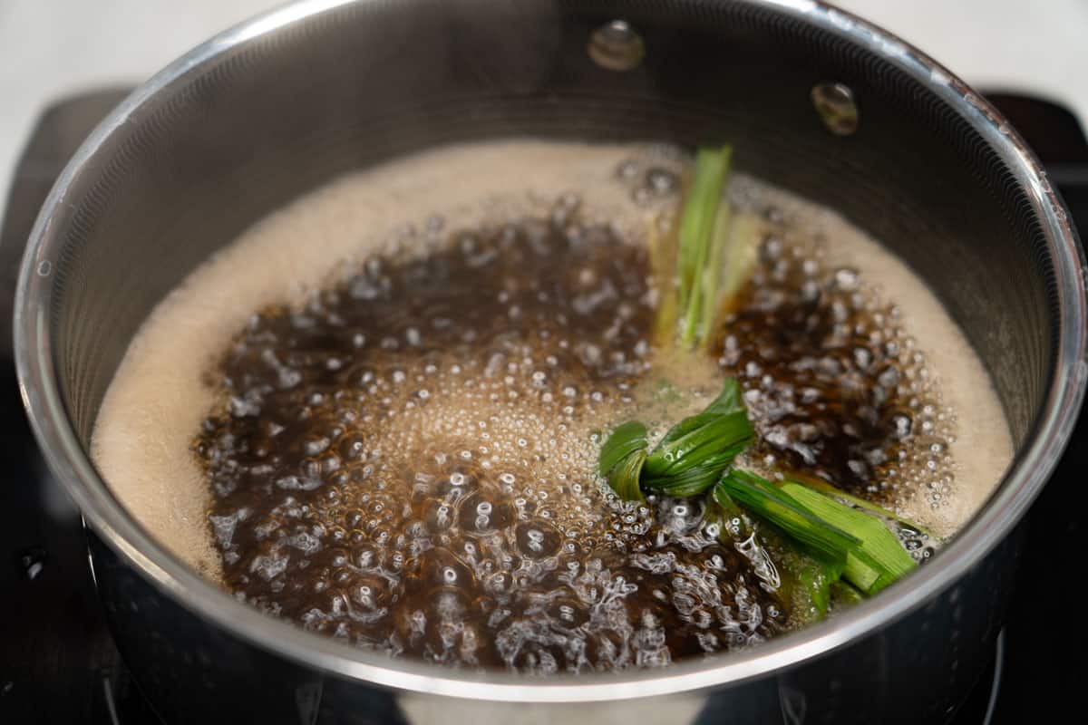 Sugar syrup for Minatamis na Saging (Sweetened Saba Bananas) simmering in a saucepan.