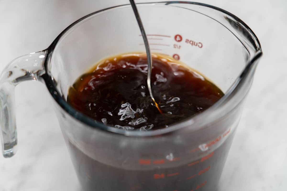 Mixing pancit canton sauce in a measuring cup.