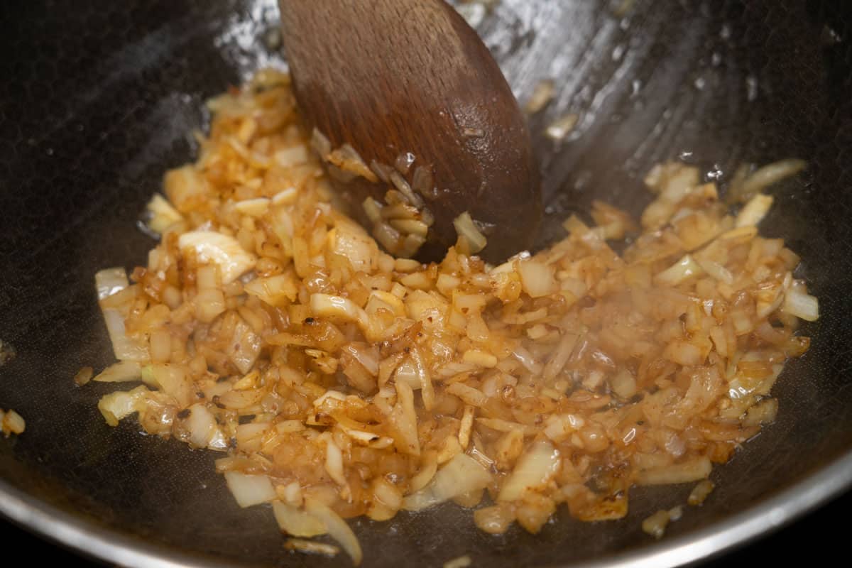 Sauteing aromatics in a pan.