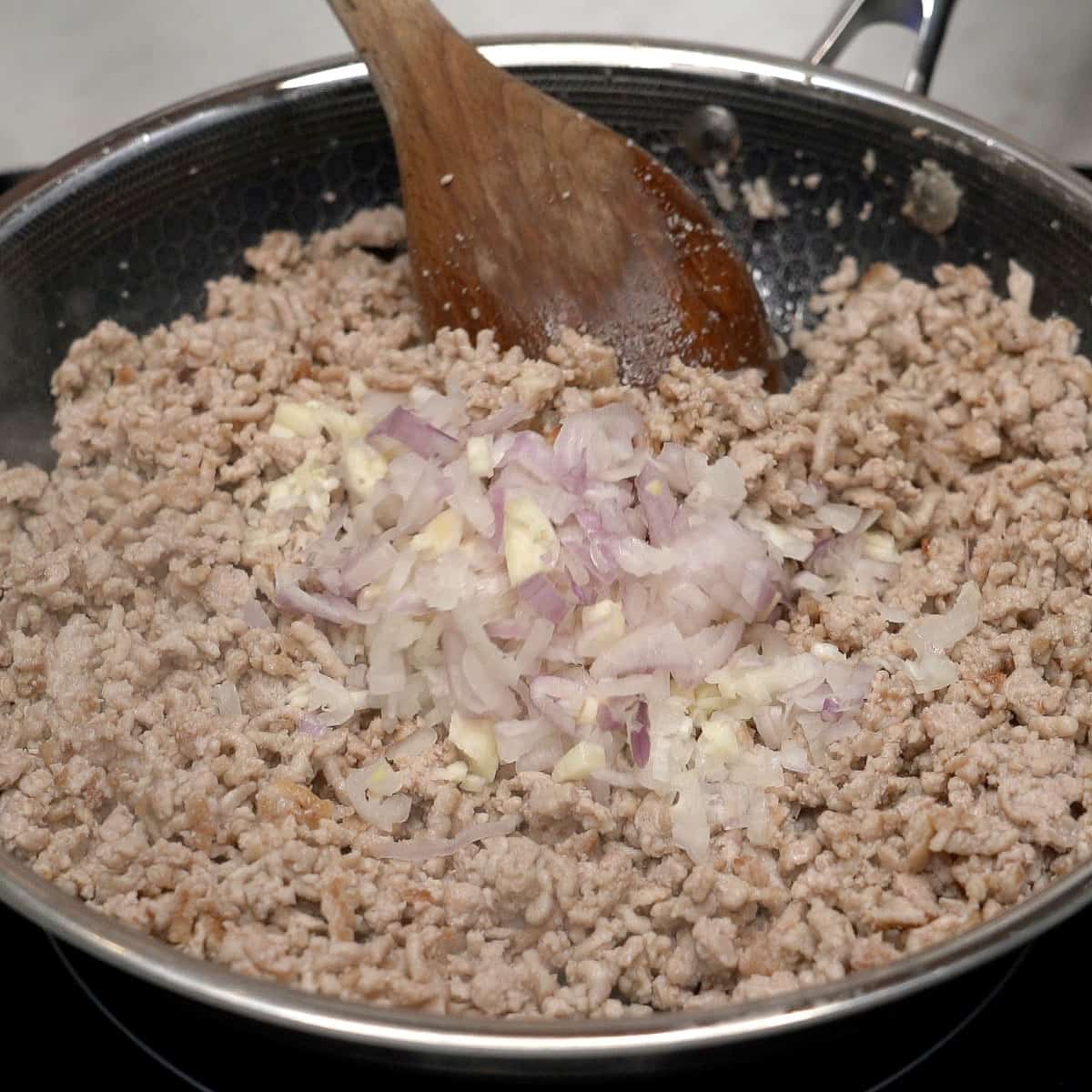 Ground pork and aromatics in the pan.