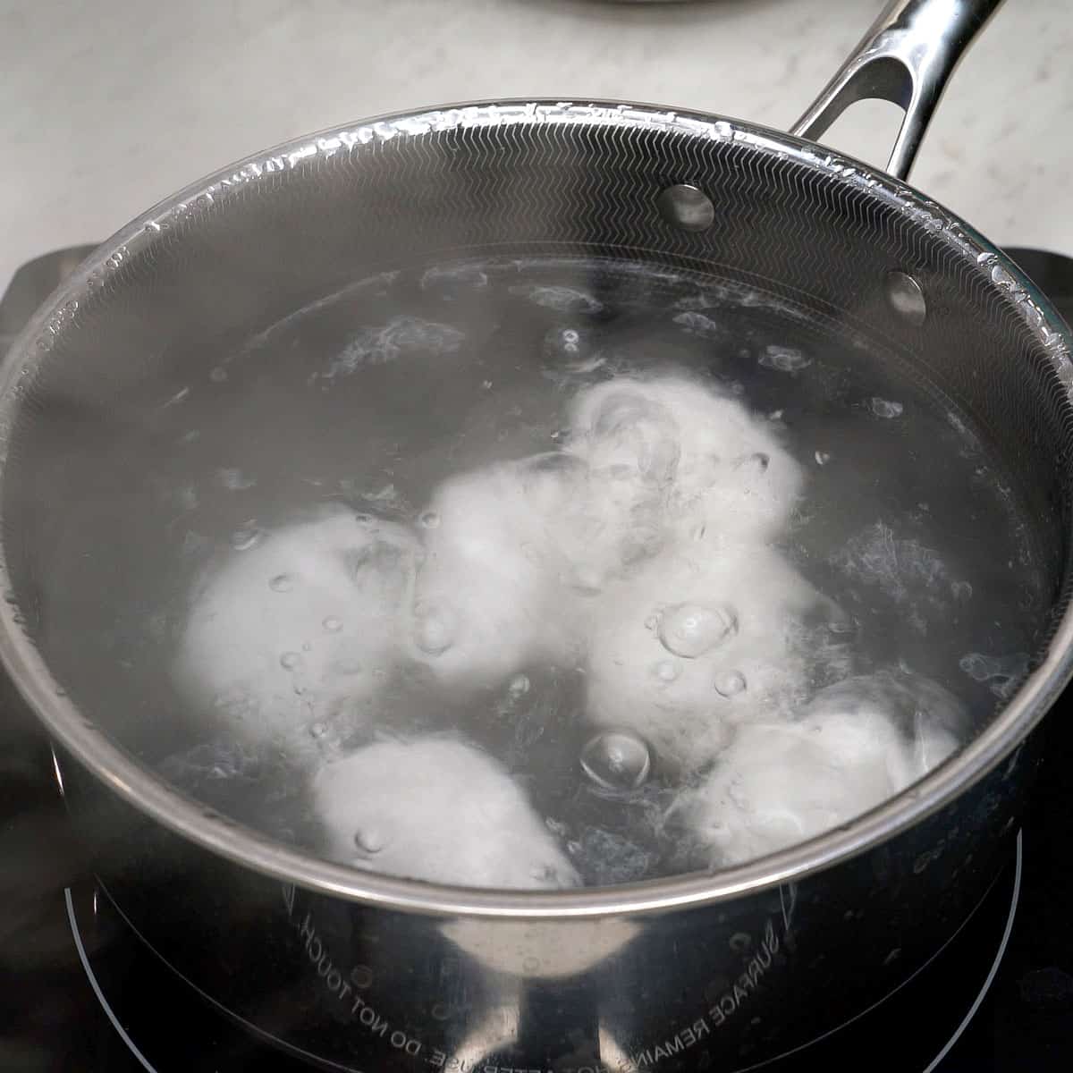 Boiling eggs in a pot.