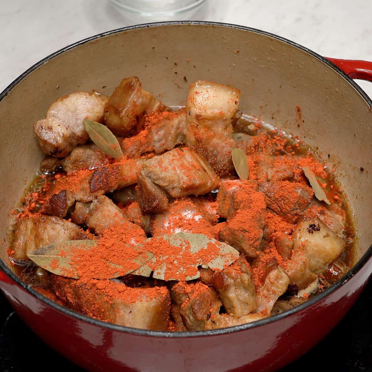 Adobong pula ingredients in a pot.