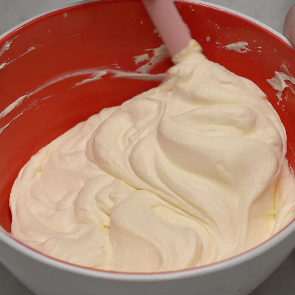 Pudding mixture and whipped cream mixed in a bowl.