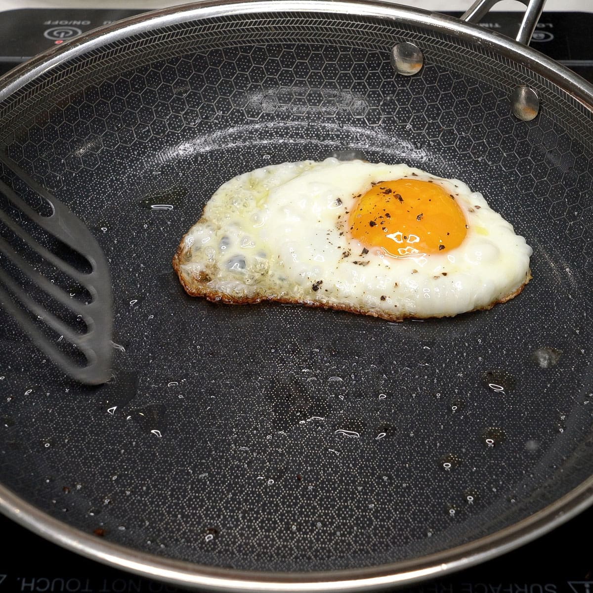 Frying an egg in a pan.
