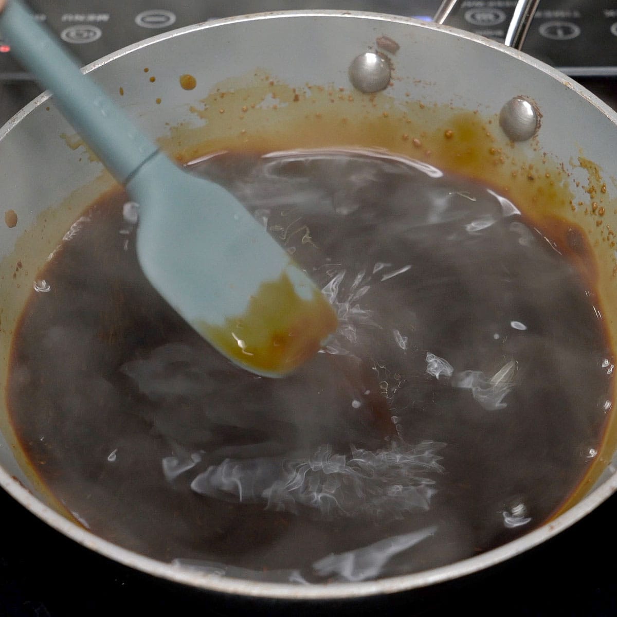 Mixing the adobo sauce in a pan.