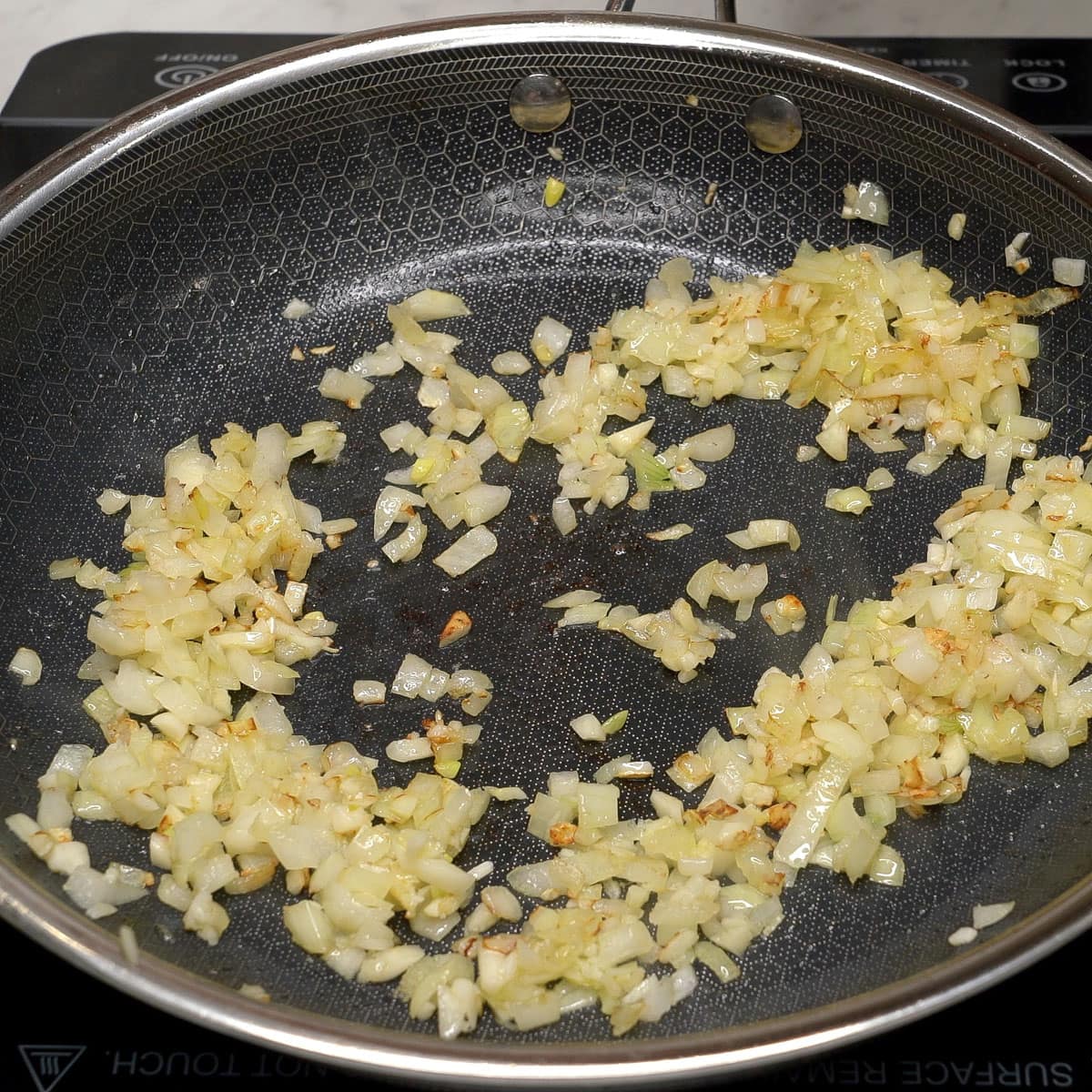 Sauteing the vegetables in a pan.