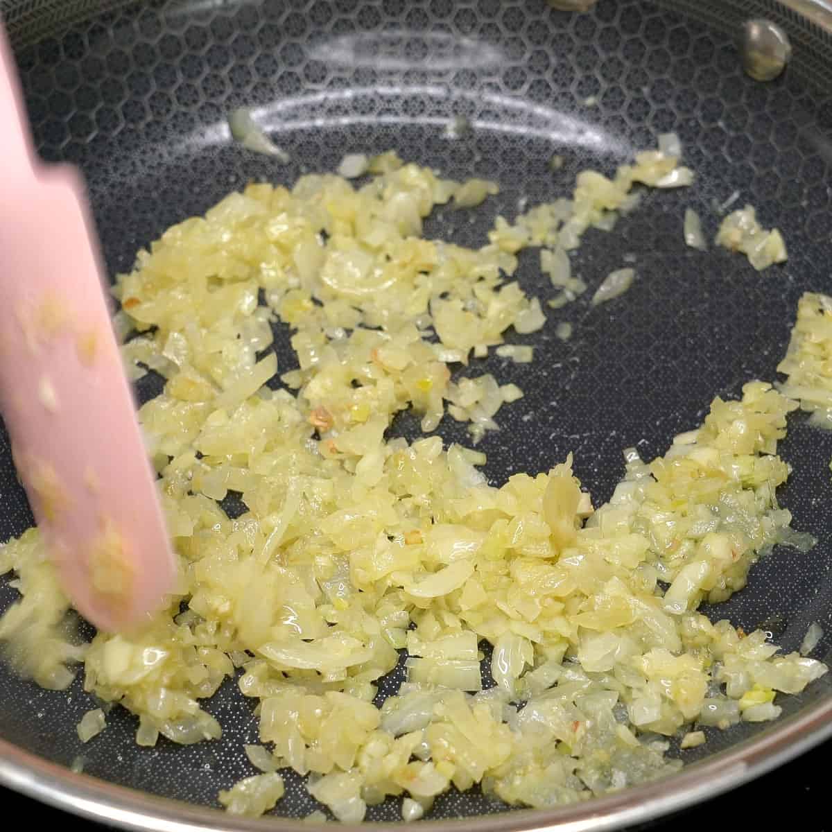 Sauteing garlic and onion in a pan.