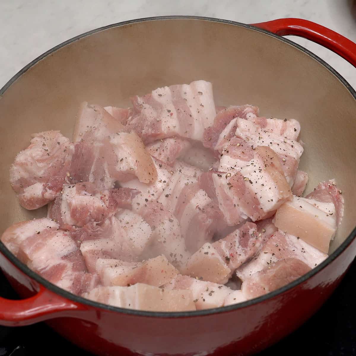 Seasoned pork belly in a pot.