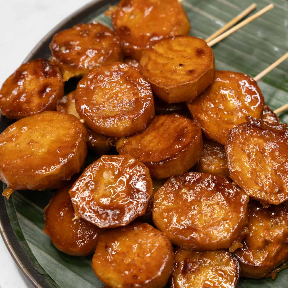 Kamote cue skewers on a plate.