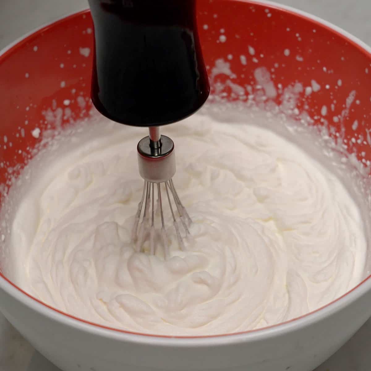 Whipping heavy cream in a bowl.