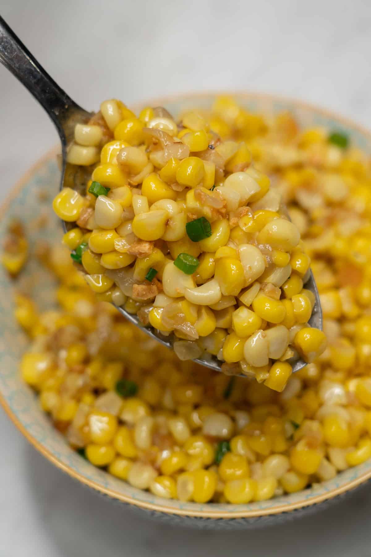 Adobong mais on a spoon.