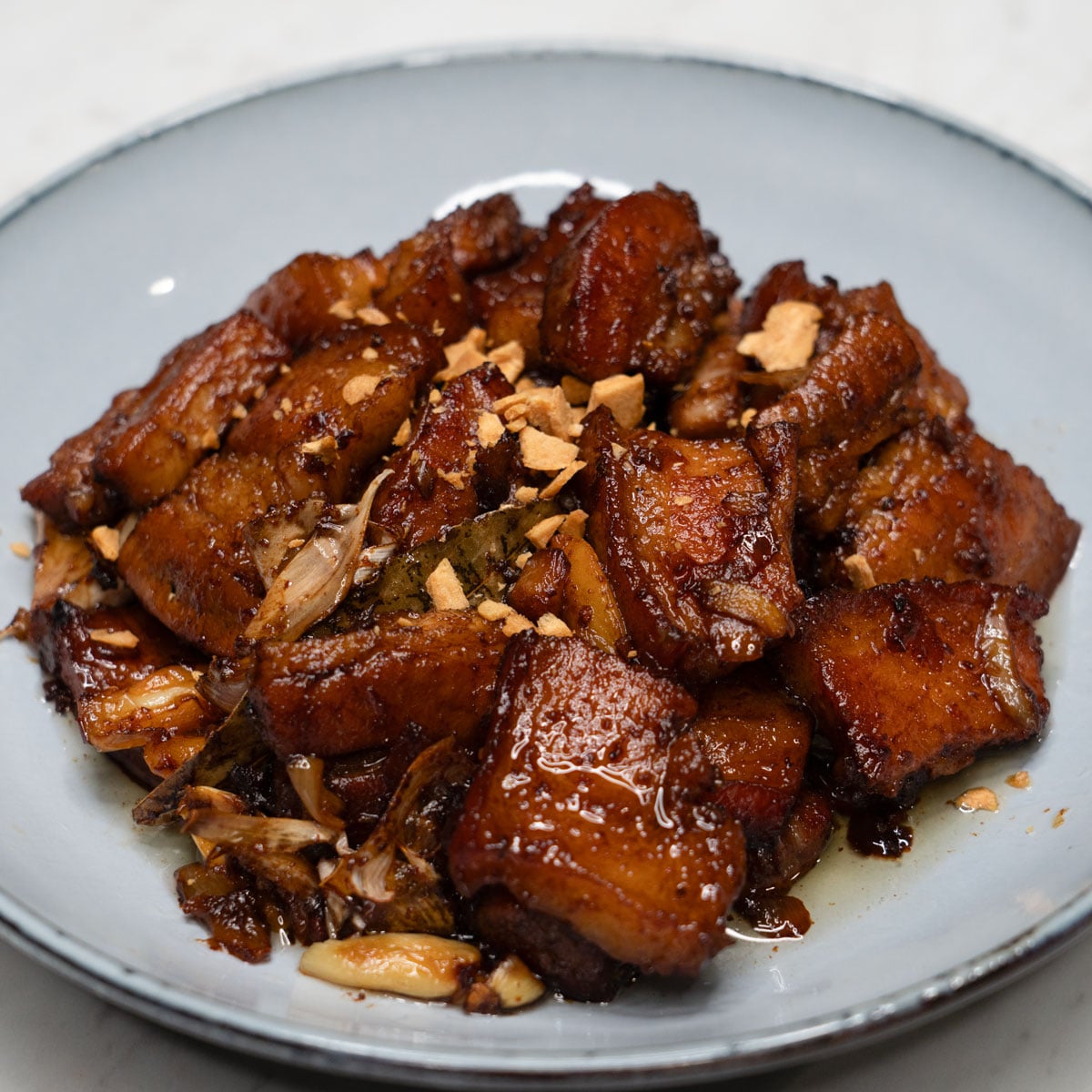Adobong tuyo with fried garlic on a plate.
