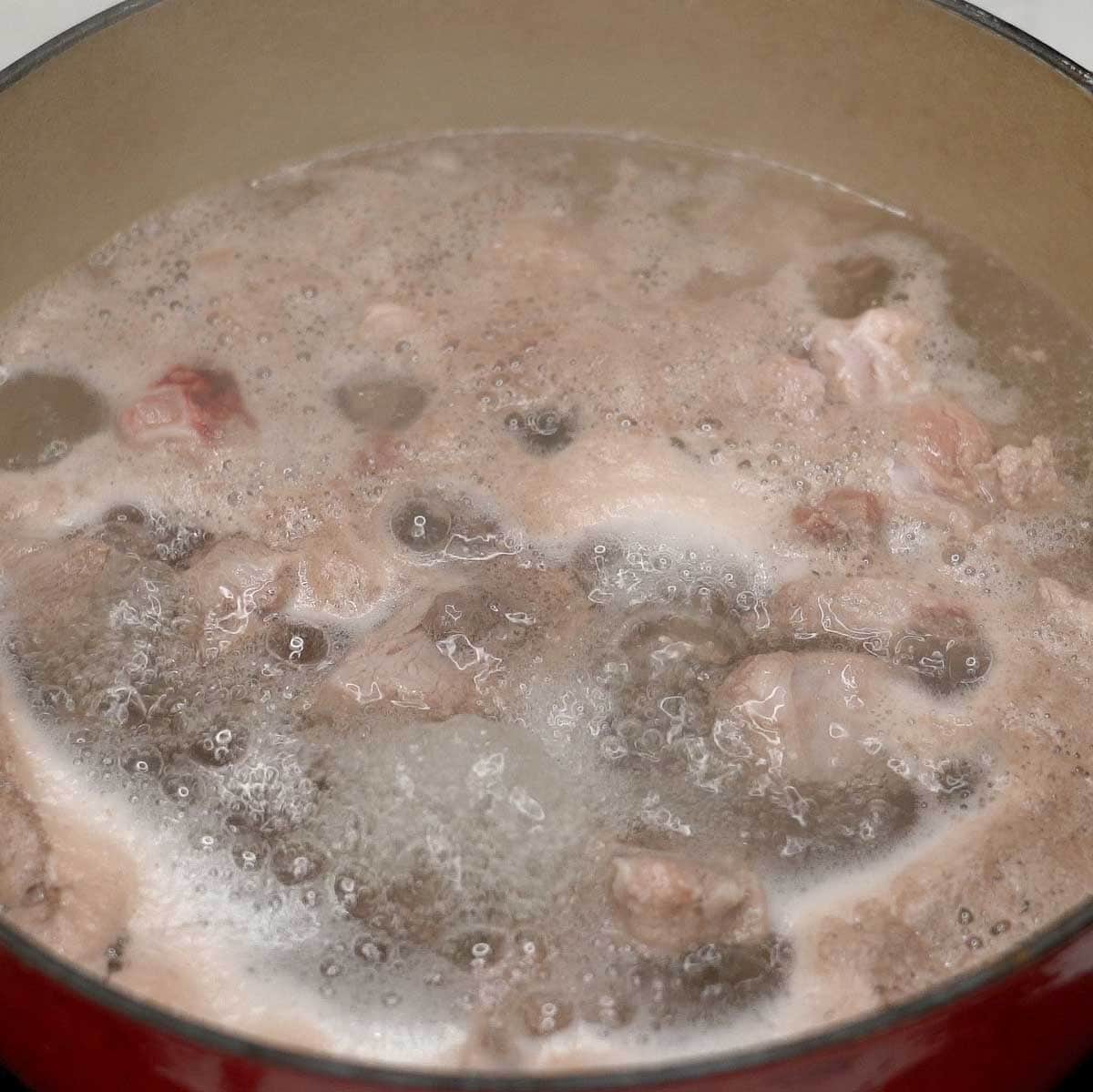 Parboiling the ribs in a pot.