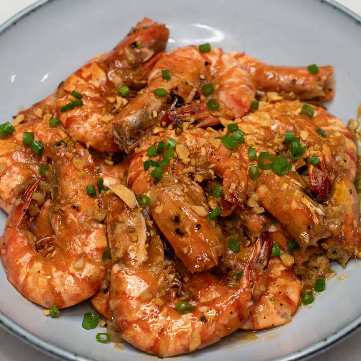 Adobong hipon topped with fried garlic and scallions.