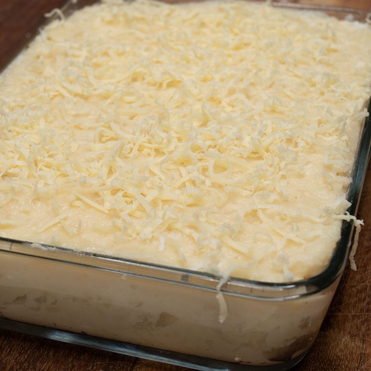 Nilupak na kamoteng kahoy in a glass dish.