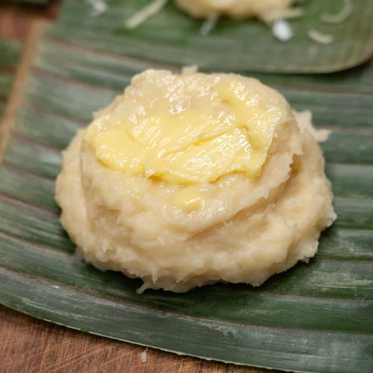 Nilupak na kamoteng kahoy topped with butter.