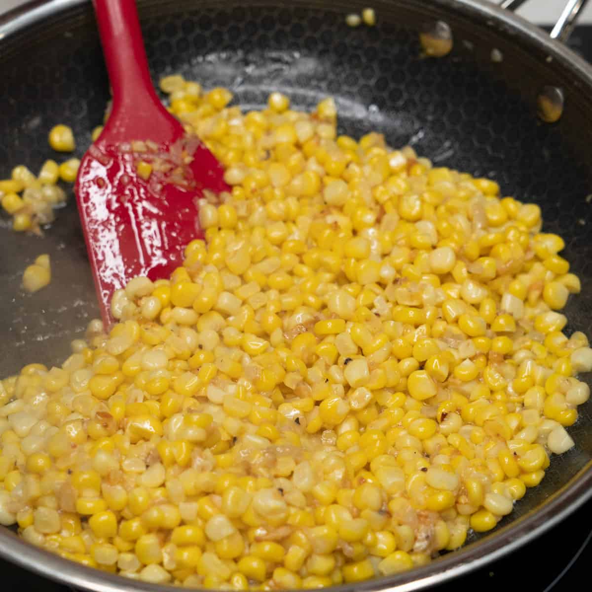 Sauteing aromatics with corn.