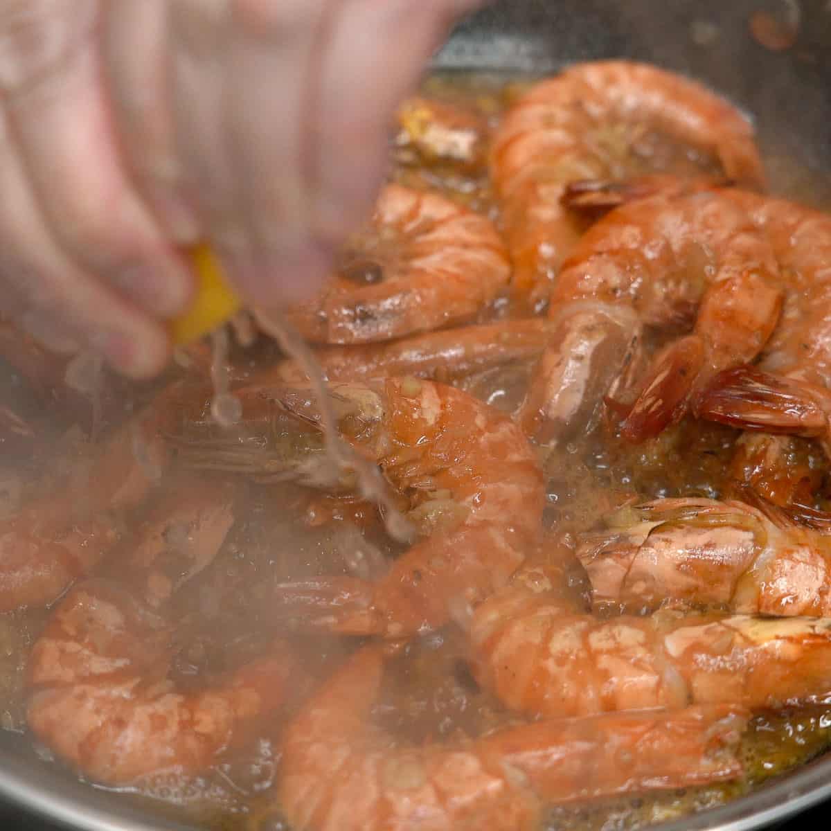Squeezing lemon on adobong hipon.