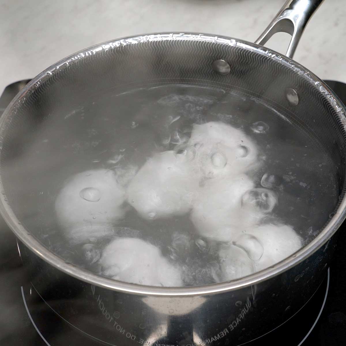 Boiling eggs in a pot.