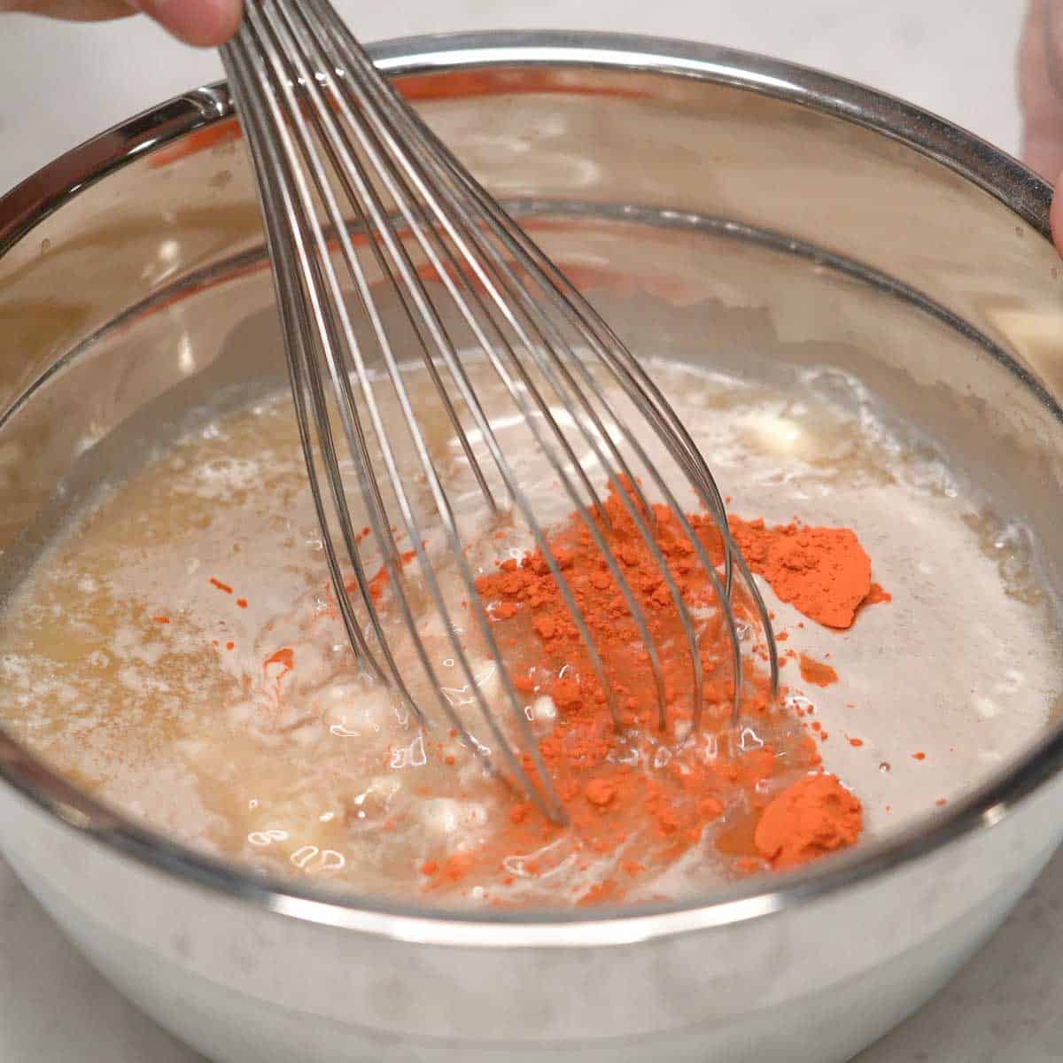 Mixing the kutsinta bottom layer in a bowl.