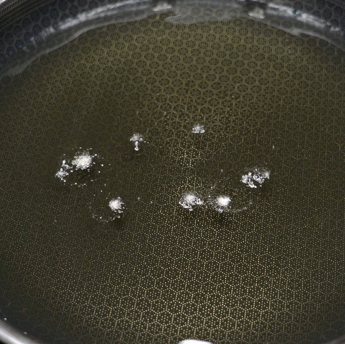 Testing the oil with a few drops of the batter.