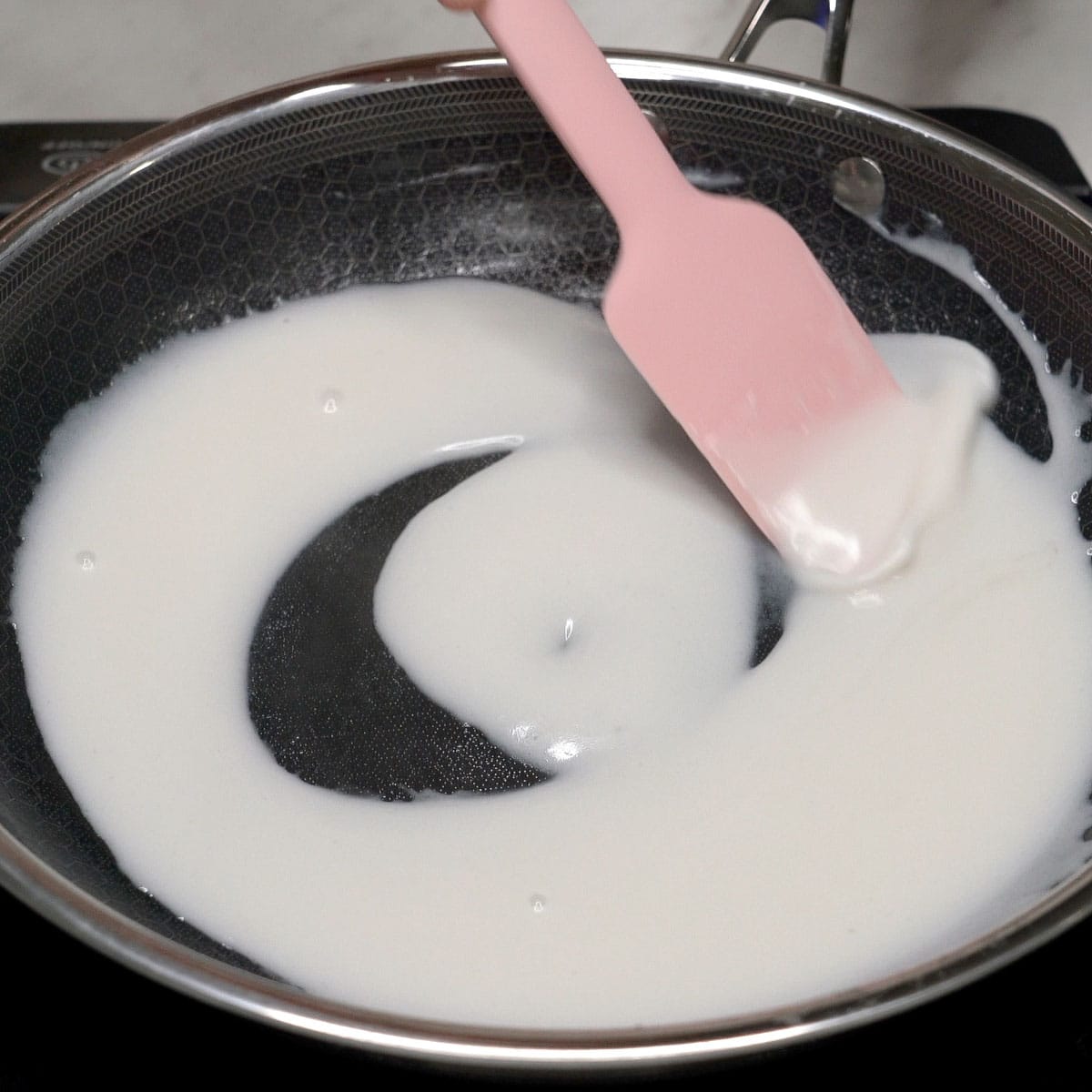 Cooking the coconut cream topping in the pan.