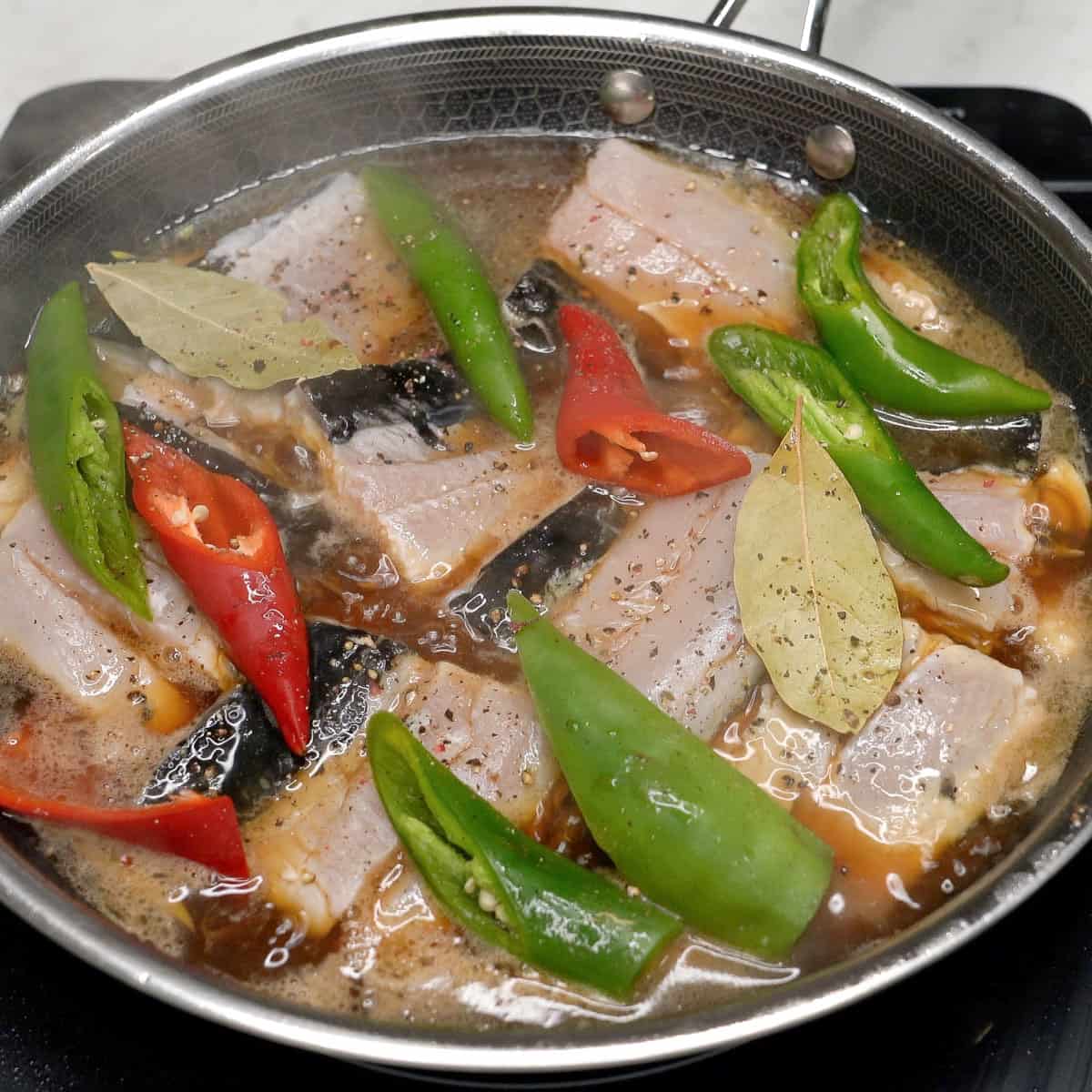 Adobong bangus simmering in the pan.