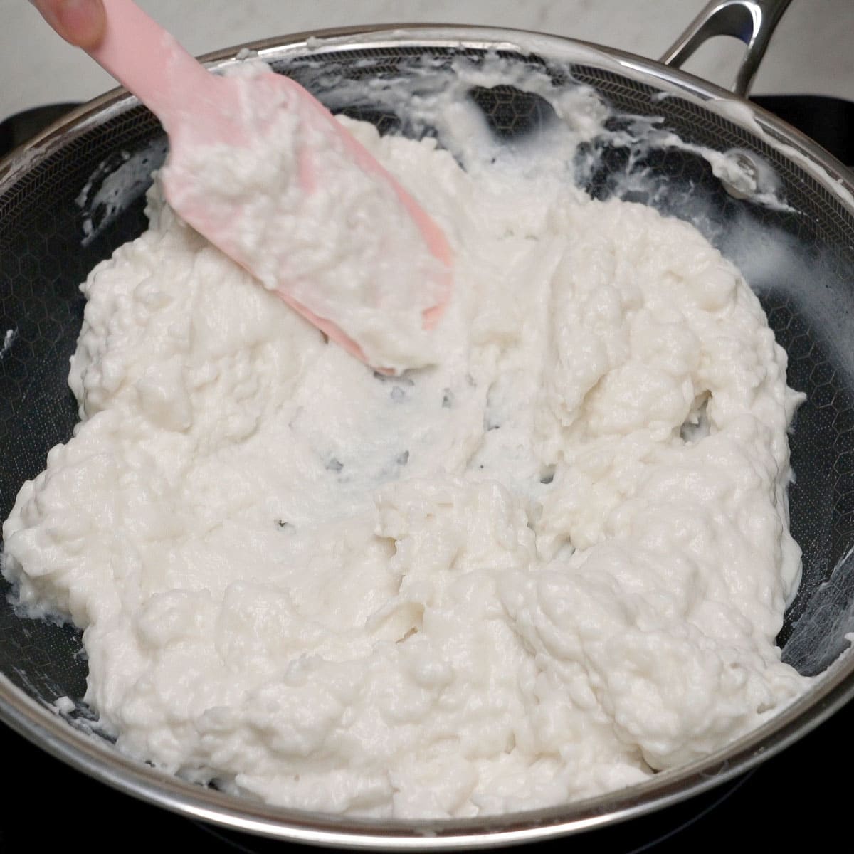 Cooking the white layer in the pan.