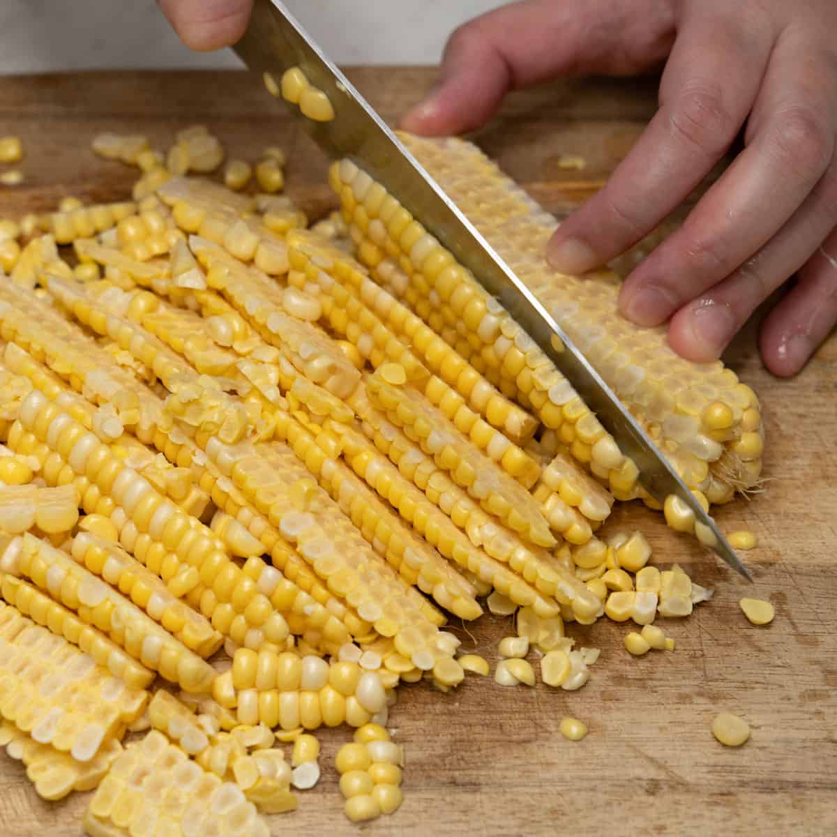 Cutting the corn from the cob.