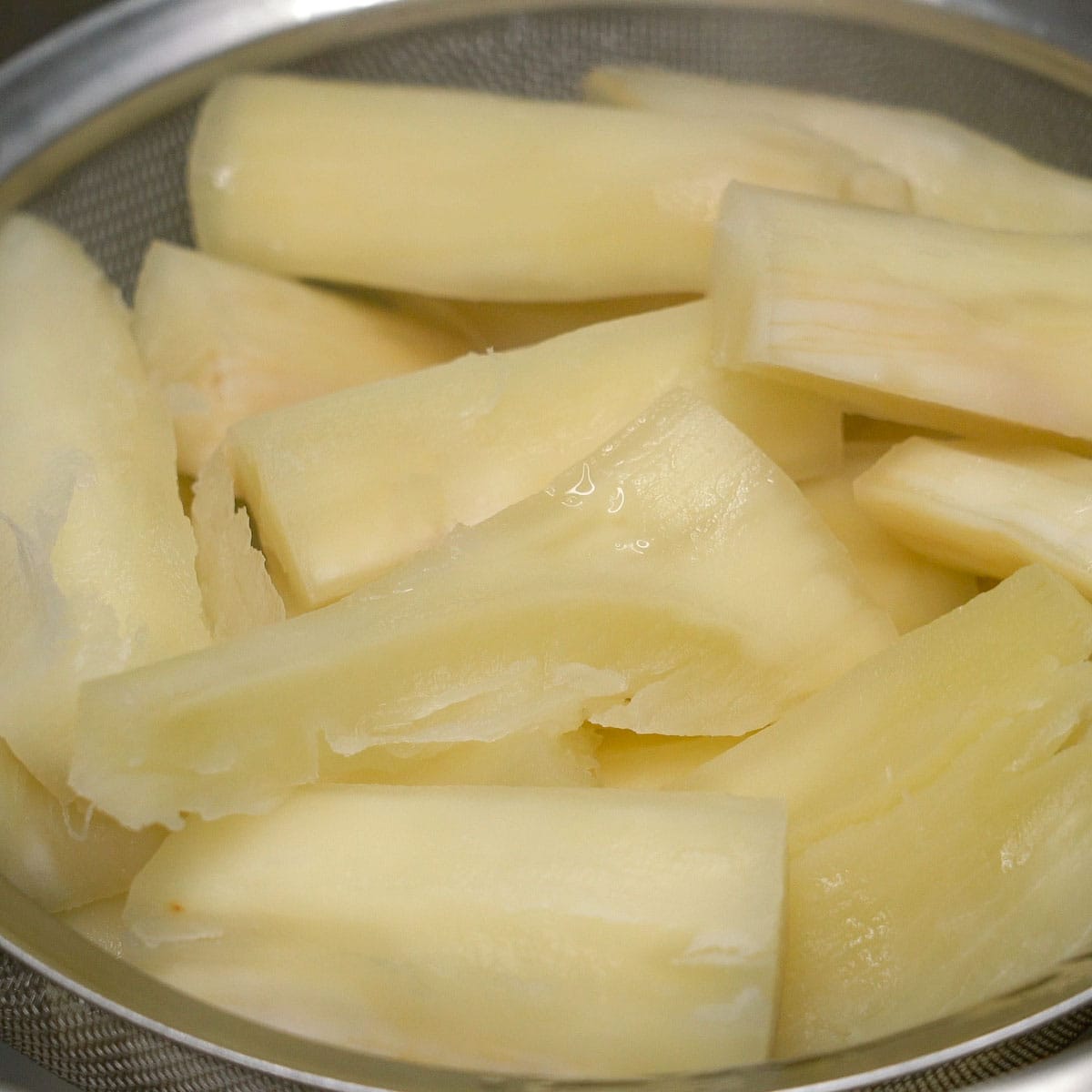 Boiled cassava on a strainer.