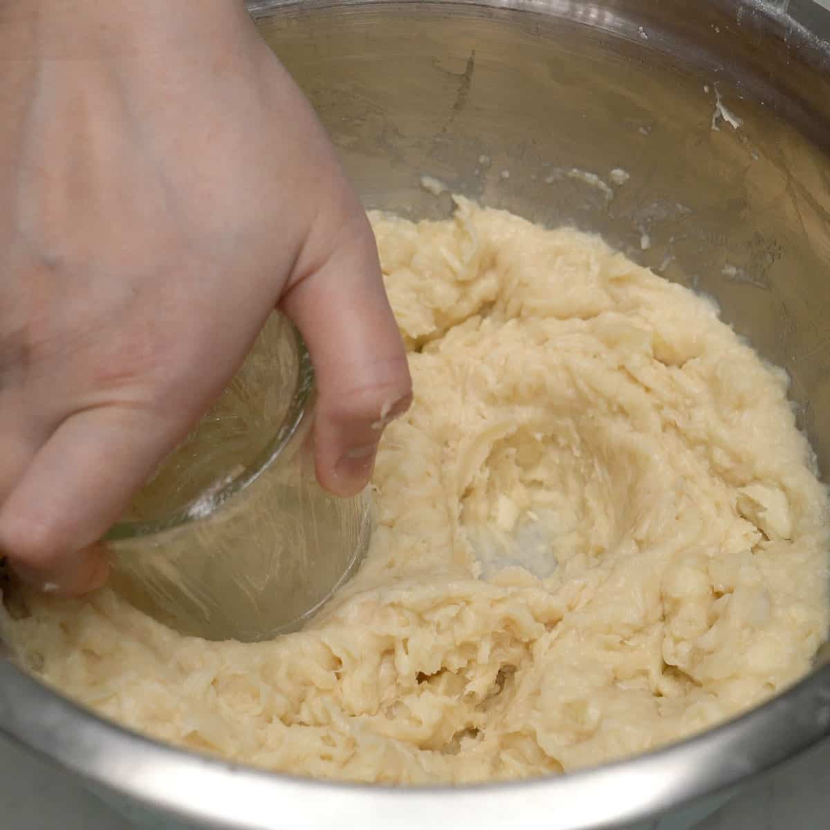 Mashing cassava in a bowl.