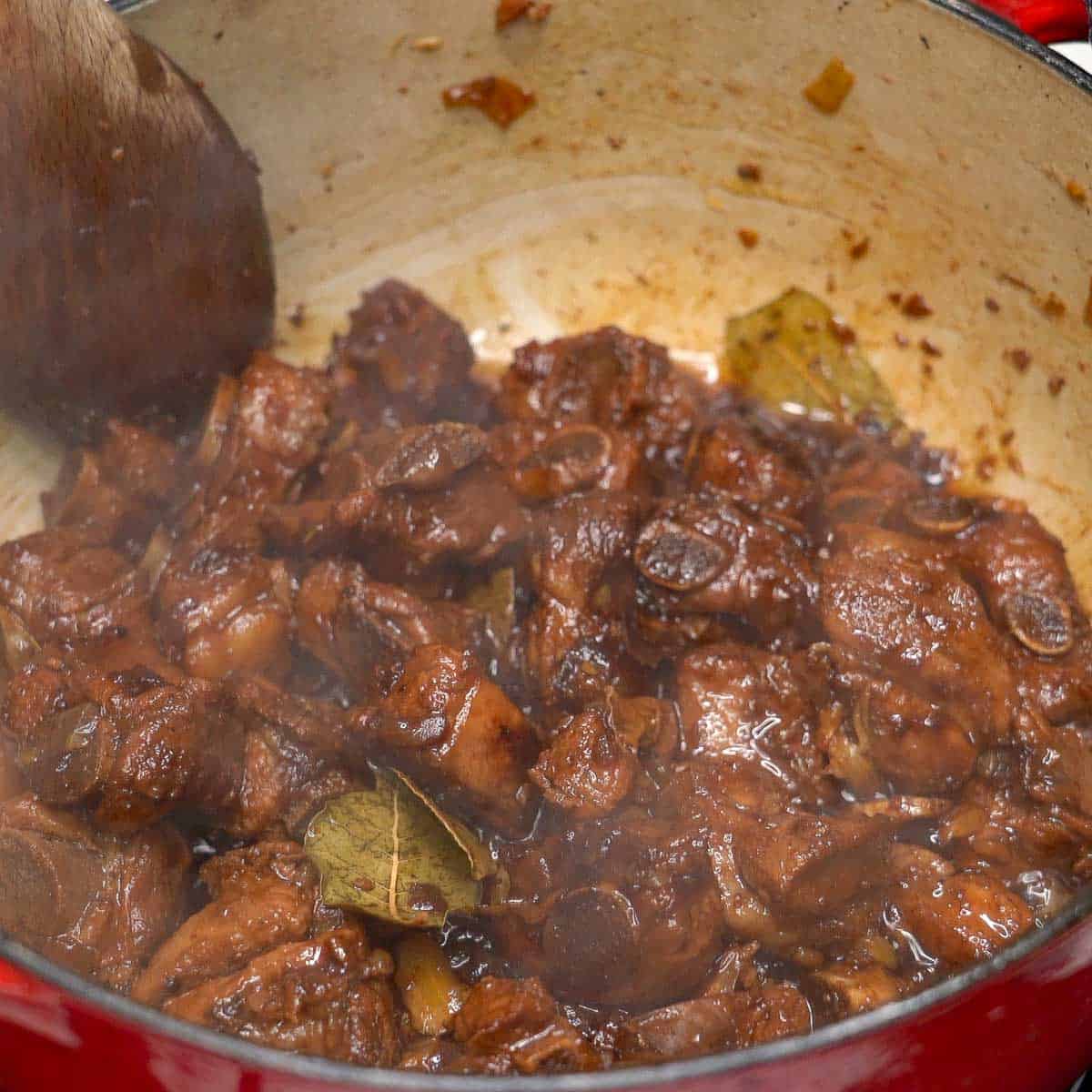 Cooked pork ribs adobo in a pot.