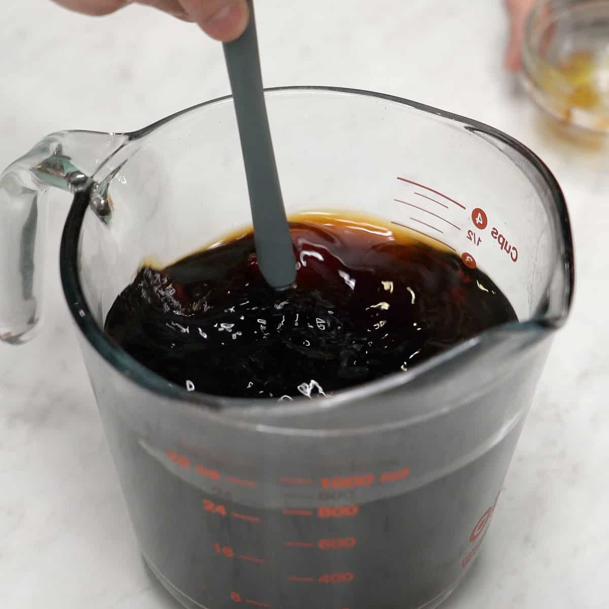 Mixing sauce in a cup.