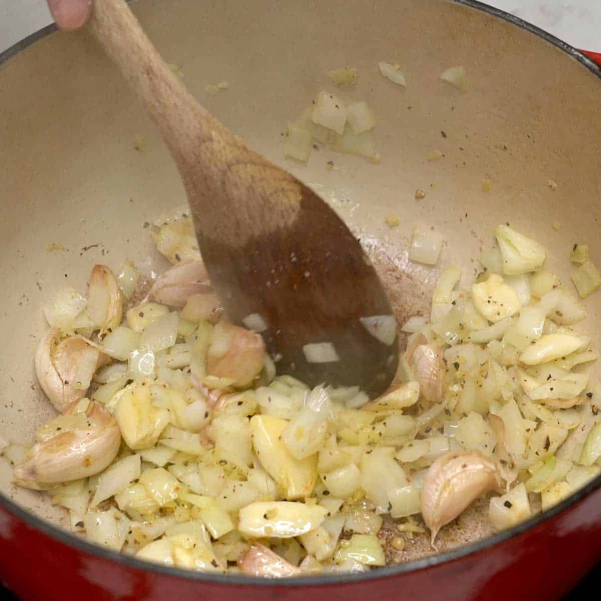 Sauteing aromatics in a pot.