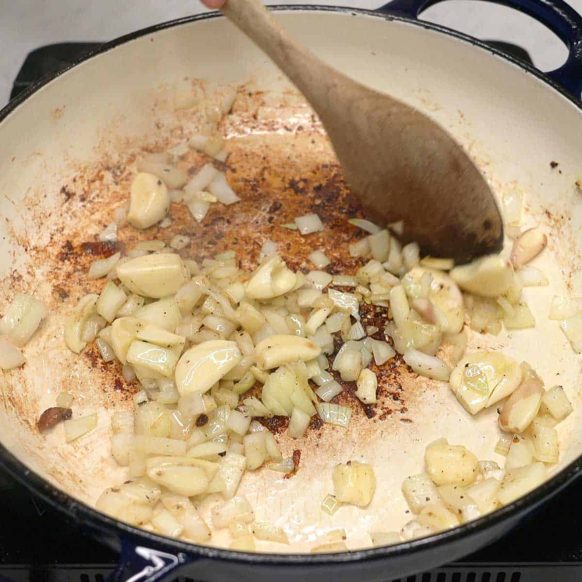 Sauteing aromatics in a pan.