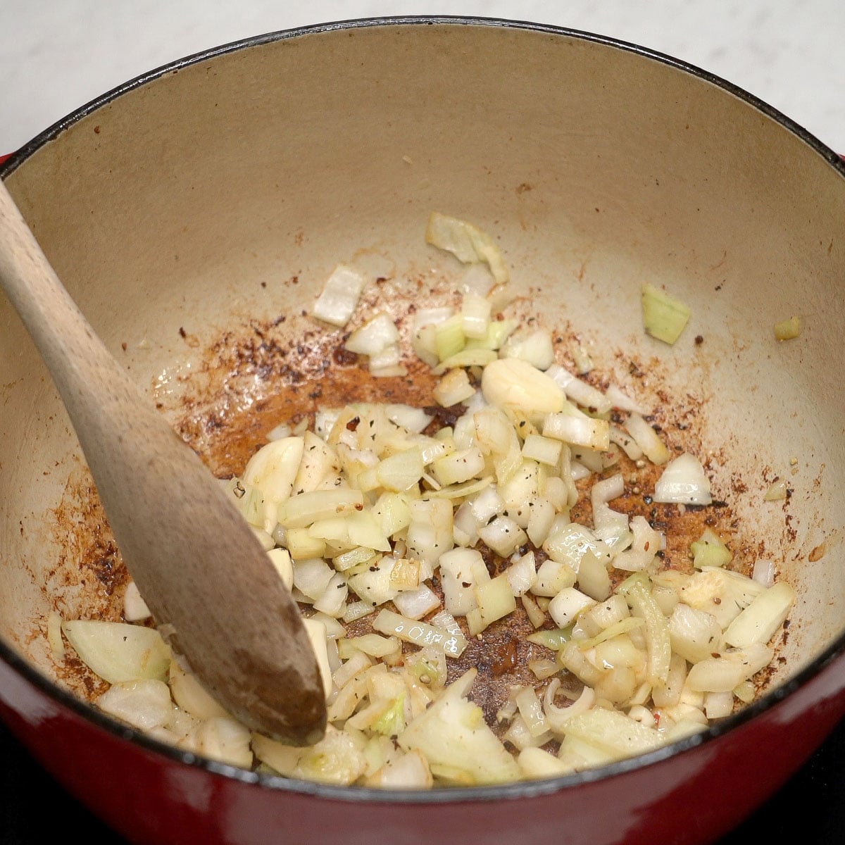 Sauteing the aromatics in a pot.