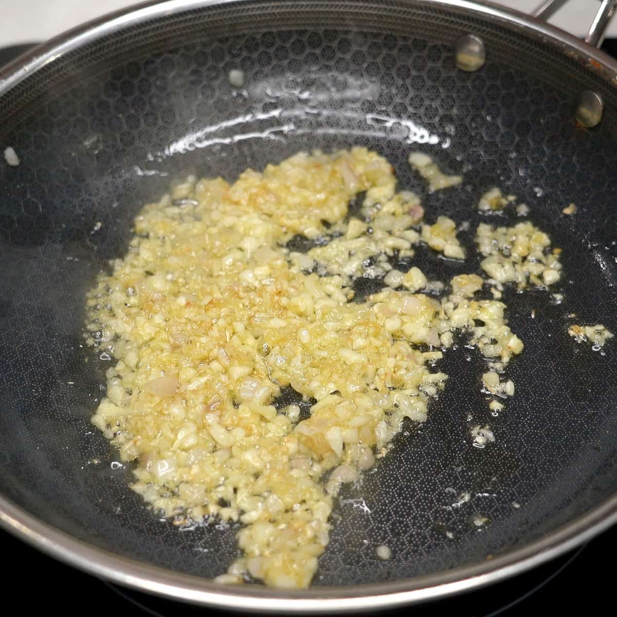 Sauteing aromics in a pan.