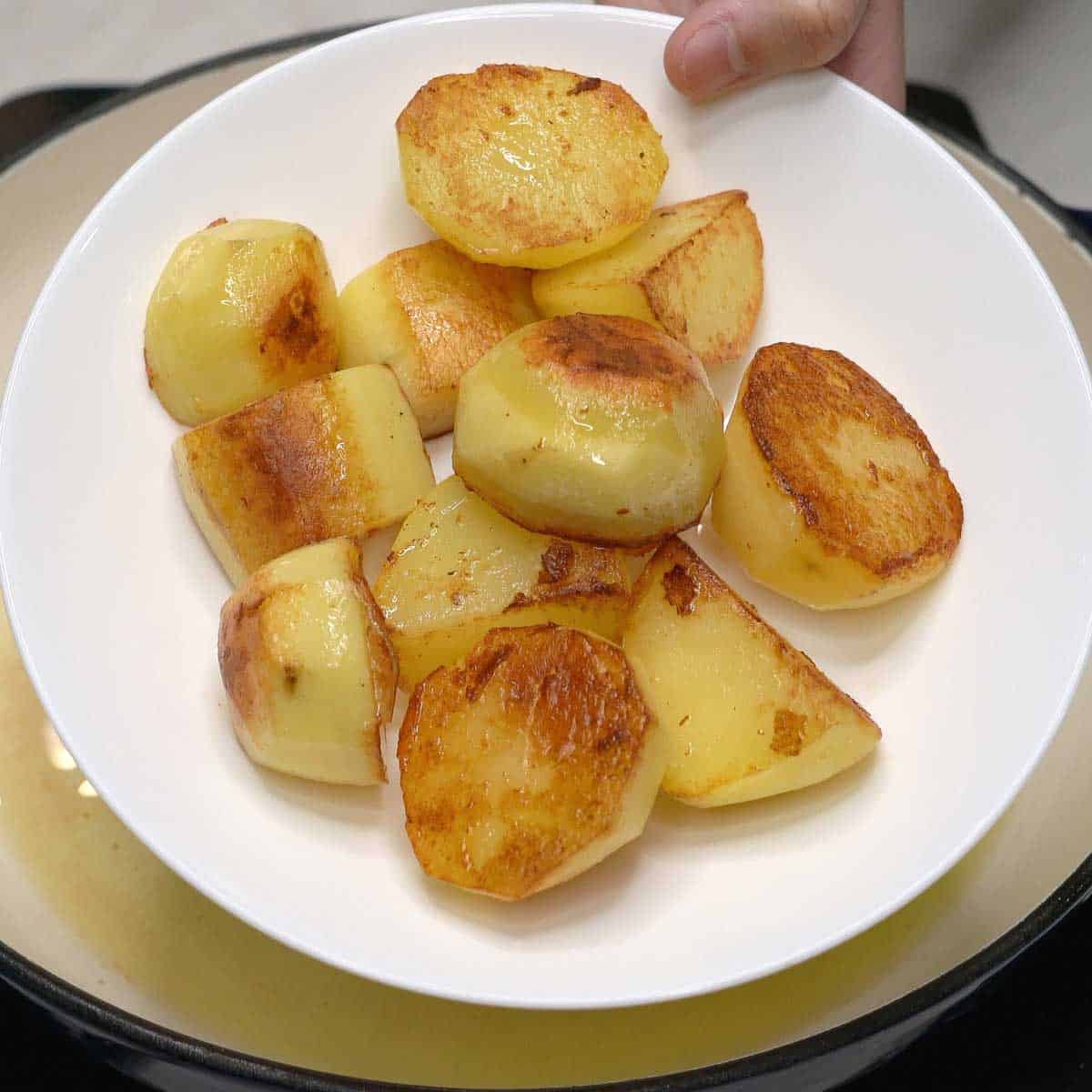 Browned potatoes in a bowl.