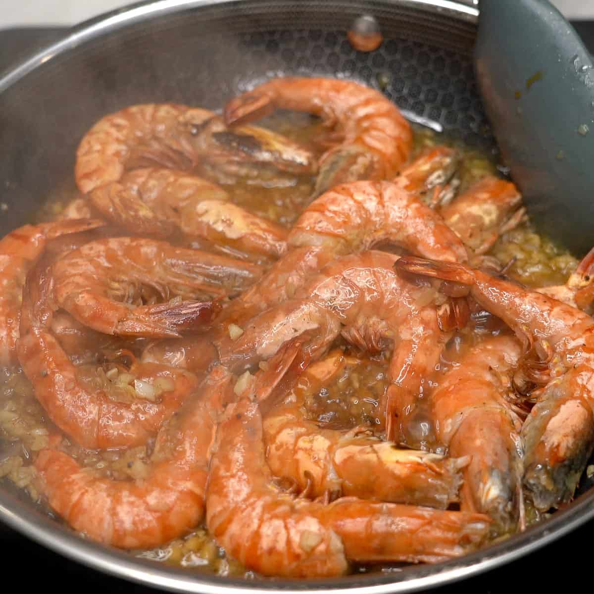 Shrimp with adobo sauce in the pan.