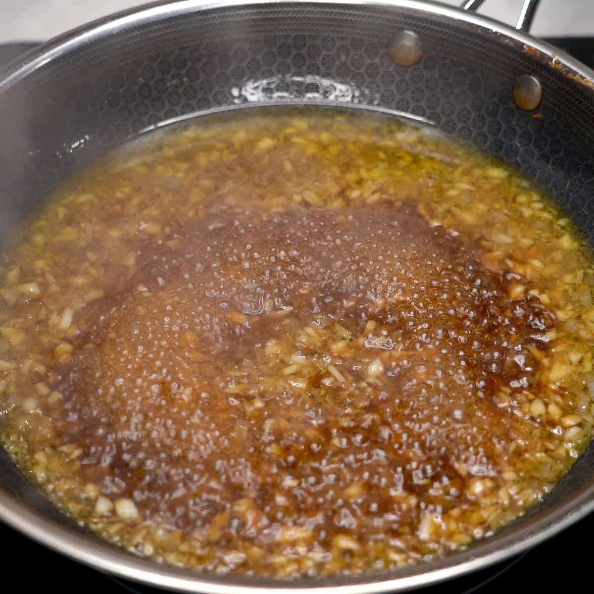 Adobong hipon sauce simmering in the pan.