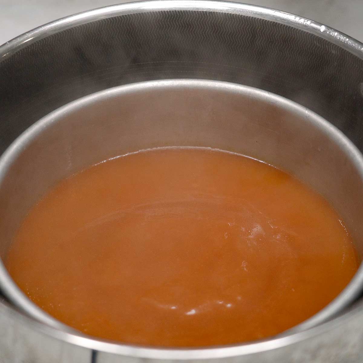 Partially cooked kutsinta bottom layer in a steamer.